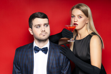 Concept of Halloween, young man and woman on red background