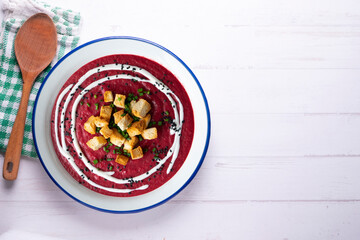 Beetroot and vegetable cream with bread croutons and cream. vegan soup.