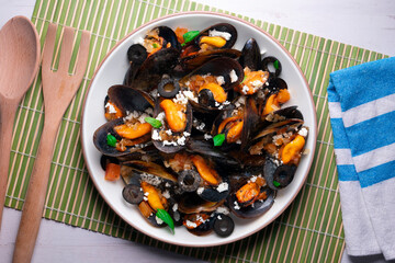 Steamed mussels with tomato sauce and feta cheese. Typical Greek recipe.