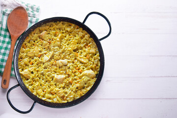 Paella with vegetables and chicken. Typical Spanish tapas recipe.