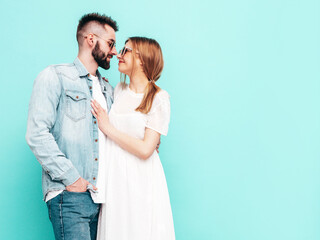 smiling beautiful woman and her handsome boyfriend. Happy cheerful family having tender moments near wall in studio. Pure cheerful models hugging. Embracing each other. Cheerful and happy