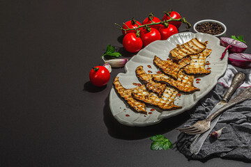 Fried slices Pleurotus eryngii mushrooms with balsamic sauce and sesame seeds. Spices and herbs