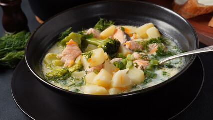 Fototapeta na wymiar Creamy fish soup with salmon, potatoes, onions , carrots, dill and broccoli. Kalakeitto- traditional dish of the Finnish cuisine. Healthy Food Concept. Omega -3