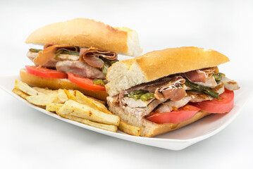 Sandwich Serranito typical in Andalusia with ham, green pepper and grilled pork loin