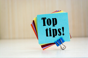 Text sign showing Top tips