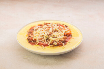 Polenta with tomato, cheese and mince