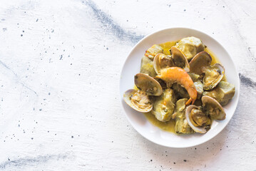 Artichokes with clams and prawns, typical traditional Spanish food for Christmas and New Year