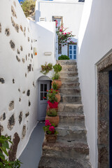Ceramic flower pots on steep stone steps at Imergovigli, Santorini, Greece