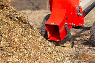 Garden shredder. A pile of wood chips with a branch crusher. Mulch bark for decoration and weed...