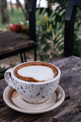 coffee latte heart art on the black wooden table