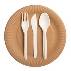 Biodegradable disposable tableware isolated on white background. Brown plate, white fork with knife and spoon close-up. Ecological biodegradable tableware.