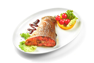 Grilled salmon tail in a white plate. White background. Selective focus. Close-up
