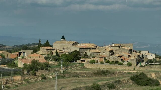 Parallax footage of picturesque Spanish small village. Aerial drone view. Sky for copy space