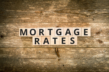 Mortgage rates on wooden background with space for text