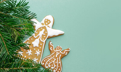 isolated gingerbread cookies man angels on green background natural green fir pine cone branches...