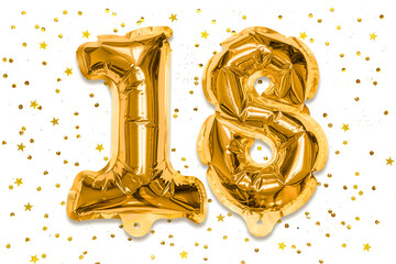 The number of the balloon made of golden foil, the number eighteen on a white background with sequins. Birthday greeting card with inscription 18. Numerical digit, Celebration event.