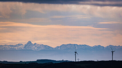 Silhouette of windmills with the mountains of Vercors mountain range in Drome (France)