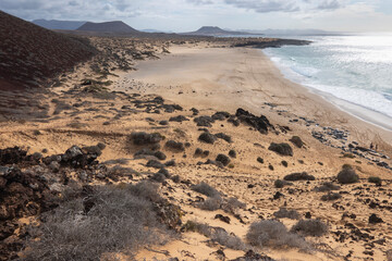 Hiking in La Graciosa Island, Canary Islands. View of the virgin beaches.