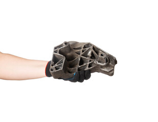 Aluminum engine cushion in the hand of a car mechanic on a white background, isolate. Engine mount replacement, close-up