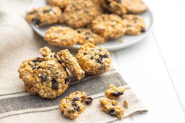 Wholegrain oat cookies. Cookies with oatmeal and raisins on white table.
