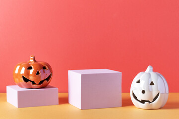 Empty product podium with Halloween pumpkin decor in pastel pink and orange colors