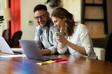 Fototapeta premium Colleagues in office. Businesswoman and businessman discussing work in office.