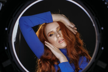 red-haired girl in blue clothes with bright make-up