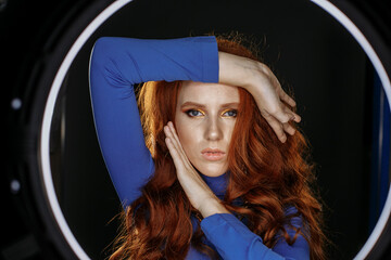 red-haired girl in blue clothes with bright make-up
