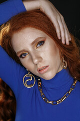red-haired girl in blue clothes with bright make-up