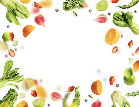 Frame of various flying or falling summer fruits, berries and vegetables on transparent background. Healthy food. Detox and dieting concept
