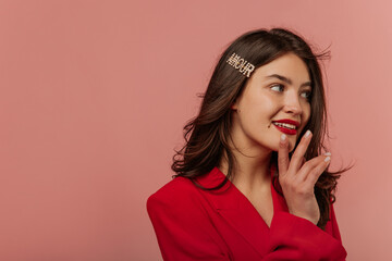 Close-up of beautiful young caucasian girl looking off to side on pink background with place of...