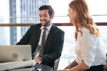 Happy businessman working with team at the office	