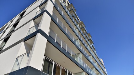 Modern luxury residential flat. Modern apartment building on a sunny day. Apartment building with a blue sky. Facade of a modern apartment building.