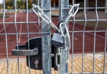 Locked metal gate with chain and padlock