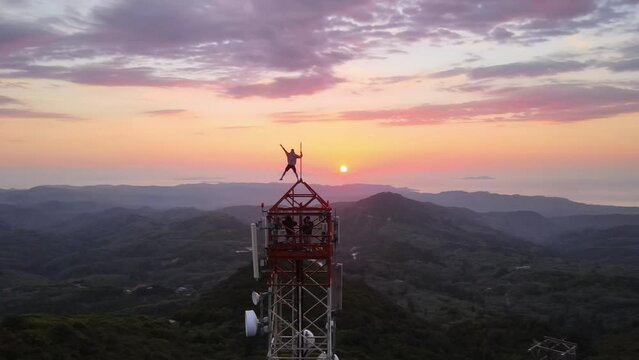 Tower climbing with an incredible view. A dose of adrenaline. Orbit drone video during sunset.