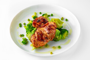 Steak with chicken or turkey with vegetables. Balanced, nutritious, tasty and nutritious food. Ready-made menu for a restaurant or for delivery. Dish in a white plate isolated on a white background.