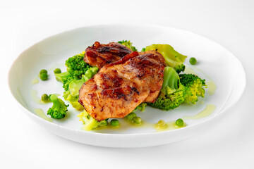 Steak with chicken or turkey with vegetables. Balanced, nutritious, tasty and nutritious food. Ready-made menu for a restaurant or for delivery. Dish in a white plate isolated on a white background.