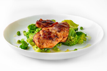 Steak with chicken or turkey with vegetables. Balanced, nutritious, tasty and nutritious food. Ready-made menu for a restaurant or for delivery. Dish in a white plate isolated on a white background.