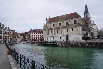 view of the old colorful buildings of the town of annecy france by the river from the bridge