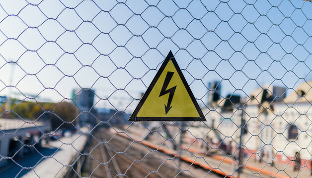 High voltage sign on the fence.