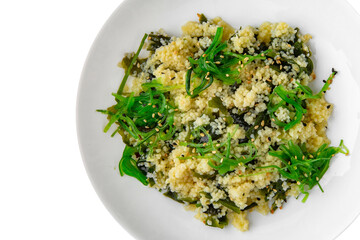Wheat porridge or bulgur with seaweed and chukka. Balanced, nutritious, tasty and nutritious food. Ready-made menu for a restaurant or for delivery. Dish in a white plate isolated on a white