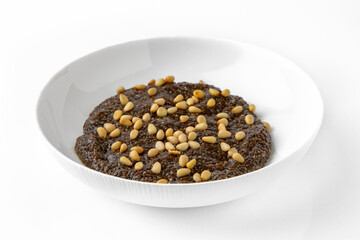 Chia with pine nuts. Balanced, nutritious, tasty and nutritious food. Ready-made menu for a restaurant or for delivery. Dish in a white plate isolated on a white background.