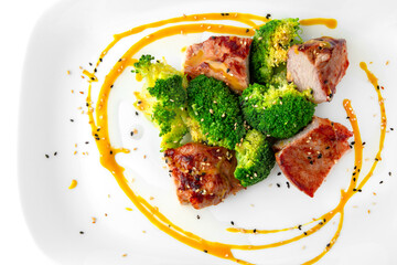 Shish kebab, pieces of meat with broccoli. Balanced, nutritious, tasty and nutritious food. Ready-made menu for a restaurant or for delivery. Dish in a white plate isolated on a white background.