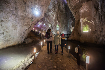 Family explore an ancient and mysterious underground cavern, adapted for the visitors.