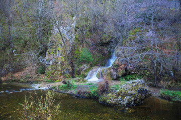 Naklejka na ściany i meble Beautiful forest waterfall, autumn day. Gostilje waterfall at mountain Zlatibor, Serbia. 