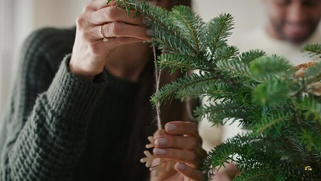 Happy couple decorating Christmas tree at home. Shot with RED helium camera in 8K.  
