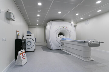 MRI machine in a hospital laboratory. Computed tomography room. General view of a huge tomograph in the hospital. - obrazy, fototapety, plakaty