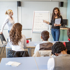 Teenage Students: Class Presentation. A student giving a presentation to her classmates. From a...