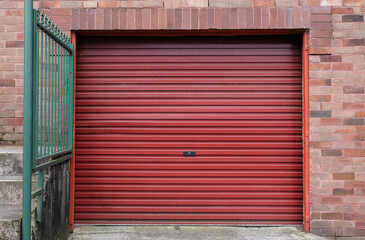 A red metal roll-up garage door at a house.