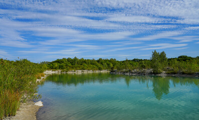 View of the Dyckerhoff lake in Beckum. Quarry west. Blue Lagoon. Landscape with a turquoise blue lake and the surrounding nature. 